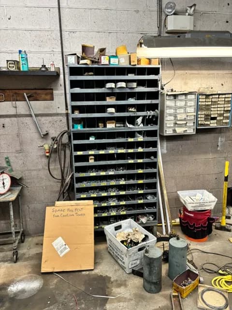 Industrial parts-bin shelving filled with hardware and fittings.