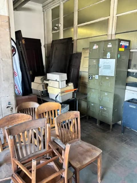 Antique wooden office chairs, steel lockers, and salvaged doors.