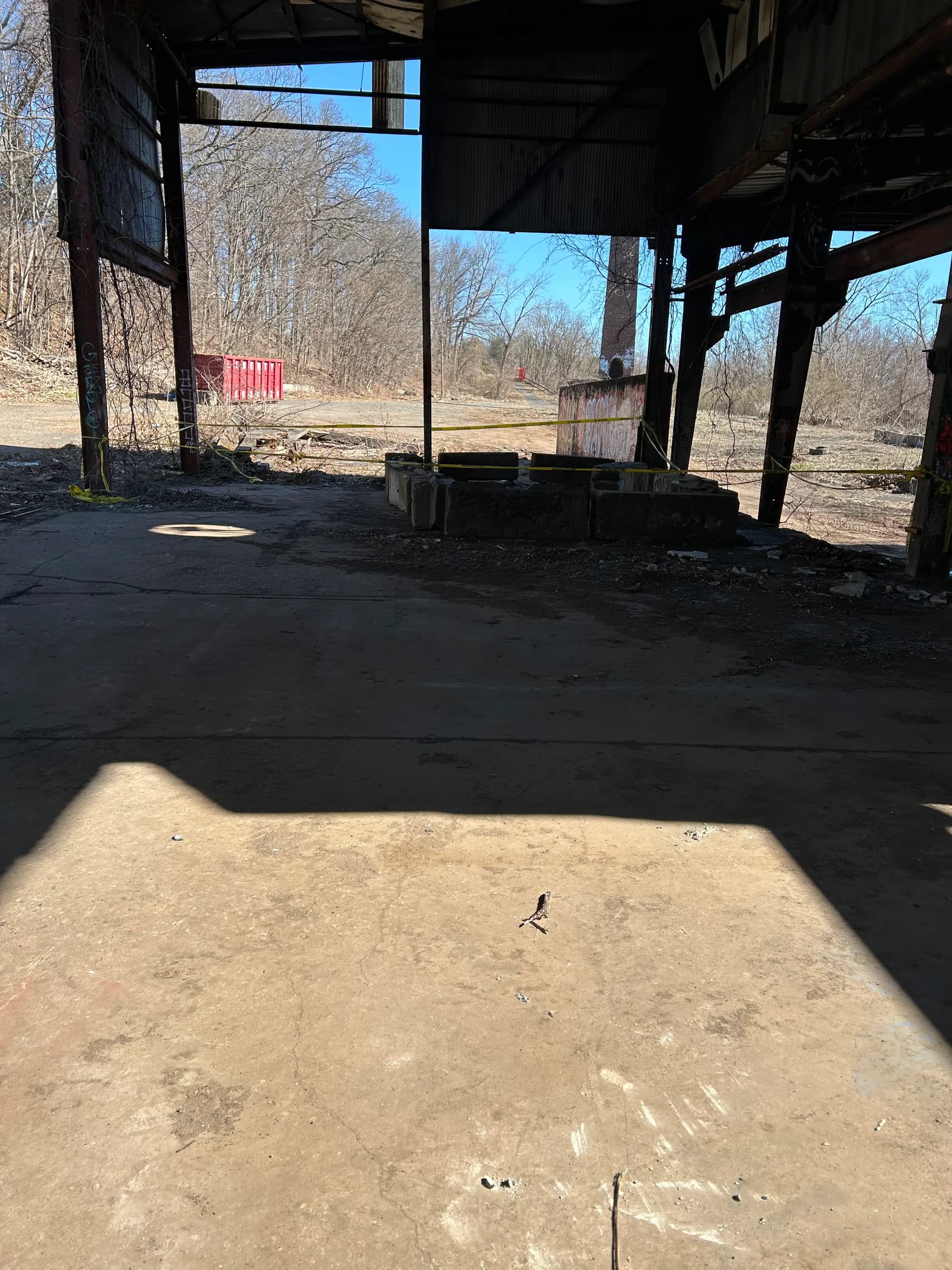 The same structure cleared to an open, swept concrete slab.