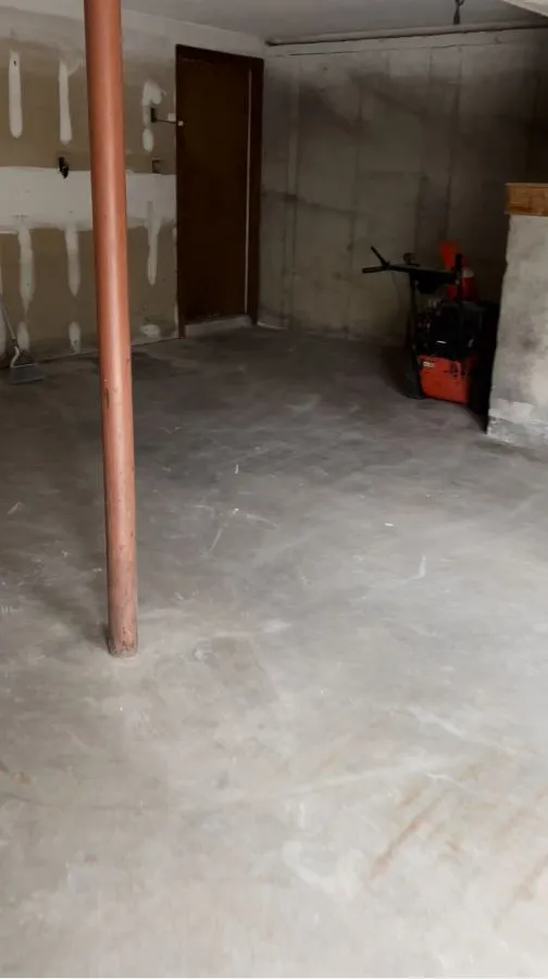 The same basement cleared and swept down to bare concrete.